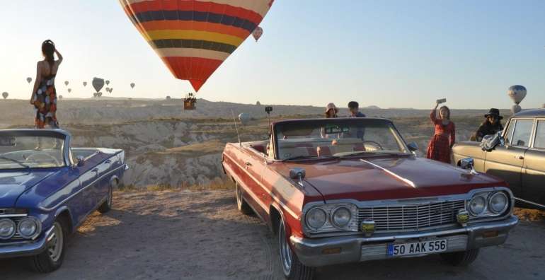 Classic car watching balloons in Cappadocia